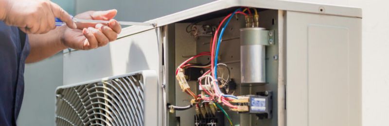 Furnace technician repairing a heating system in San Diego CA